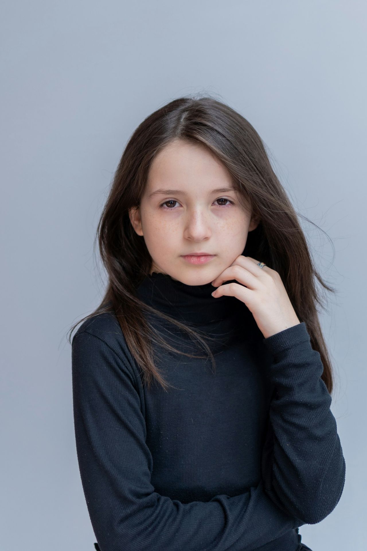 A young girl is posing for a picture